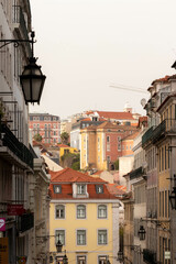Obraz premium View of Narrow Street with Colorful Buildings in the Background of Lisbon Portugal
