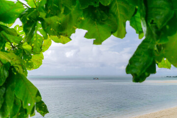 Sea view background with green leaf around the picture. Two small kayaks or canoe on tropical sea....