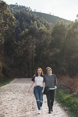 Obraz premium A mother and her daughter enjoying a nature walk on a sunny day
