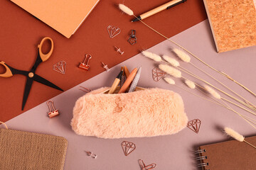Pencil case with different school stationery on colorful background