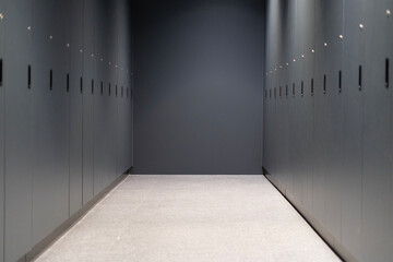 A row of closed gray cabinets in a corridor	
