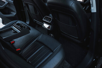 Modern black subcompact electric crossover SUV with black interior. Details interior.