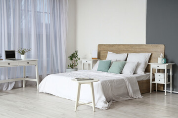 Interior of modern bedroom with workplace