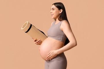 Beautiful pregnant woman with yoga mat on color background