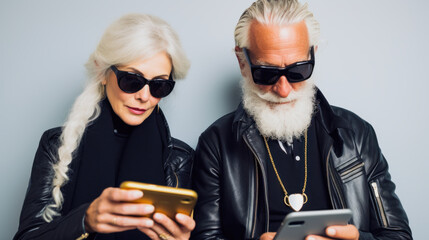 an older couple dressed in modern clothes, each with a cell phone in their hands