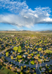 early morning with clouds over Fort Collins and foothills of Rocky Mountains in northern Colorado, springtime aerial view