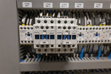 A row of contactors in a switchboard next to each other.