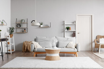 Interior of stylish living room with electric fans on table