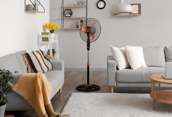 Interior of stylish living room with floor electric fan