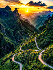 Scenic view of winding road in the mountains with the sun going down.