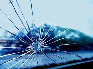 closeup of a broken glass window, with streaks formed