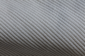 Closeup of white corduroy cloth as patterned textured background