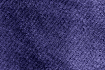 Closeup of blue violet corduroy cloth as patterned textured background