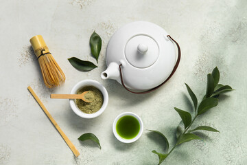 Obraz premium Bowls of matcha tea and powder with chasen on grunge background