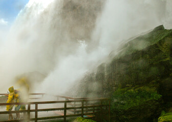 Tourists on a Niagara Falls observation boardwalk getting doused with water