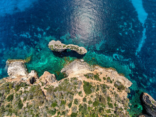 The coast of Cala D'or in South of Mallorca Spain in summer time on a sunny day with blue water and rocks