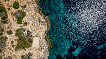 The coast of Cala D'or in South of Mallorca Spain in summer time on a sunny day with blue water and...