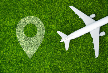Airplane and geolocation sign on the grass. Travel and business trips. Transport system and...