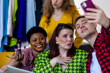 Concept of diversity, friendship between men and women, spending time together, having fun, laughing, smiling. Young people, generation z, millennial taking photo at swap party, secondhand store.