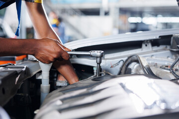 Engineer expertly examines car compressor belt using advanced mechanical tools, ensuring optimal...