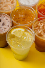Colourful summer drinks with close-up. Lemonades and coctails on yellow background