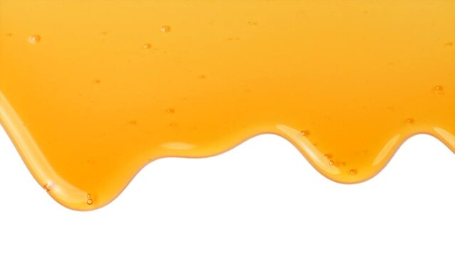 Honey dripping, pouring, flowing over white background. Close-up. Healthy organic liquid sweet sticky honey dipping, isolated on white, closeup. Slow motion. 
