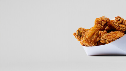Fried chicken in white paper bucket isolated on white background. Generative Ai