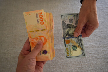exchanging US dollars for Argentine pesos, symbol for inflation in Argentina