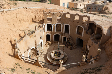Traditional ancient Berber troglodyte underground dwellings in Tunisian town of Matmata with arched...