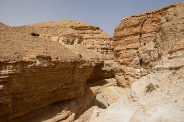 Scenic view of deserted Tamaghza canyon in Tunisia with steep sandstone cliffs, carved by time and elements ..