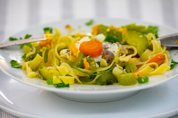 Traditional capeletti soup with chicken and vegetables. Typical winter dinner soup