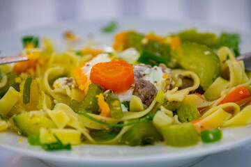 Traditional capeletti soup with chicken and vegetables. Typical winter dinner soup