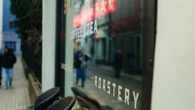 Closeup of a building facade with a roastery sign on a glass window