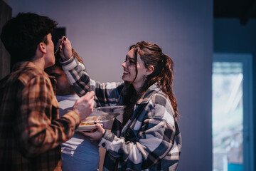 Fototapeta premium A friendly gathering indoors with a group of friends enjoying some food and each other's company.