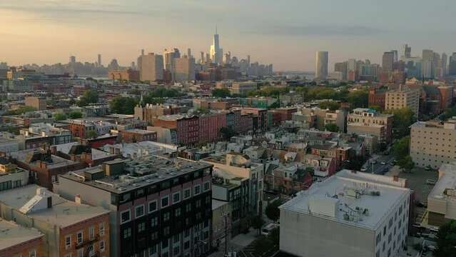 Aerial video of downtown Manhattan Freedom Tower Hoboken at sunrise homes buildings.