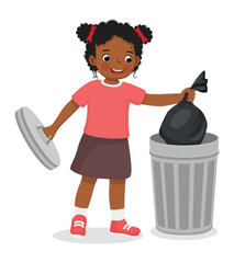 Cute little African girl taking out the trash in garbage bag into recycling bin