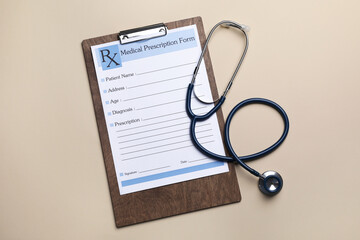 Clipboard with medical prescription form and stethoscope on beige background, flat lay