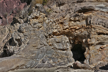 A cave is formed on the rocky foreshore  by tidal movement -Pambula New South Wales Australia.