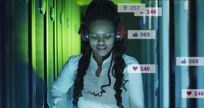 Image of icons and numbers over african american female it technician by computer servers - Powered by Adobe