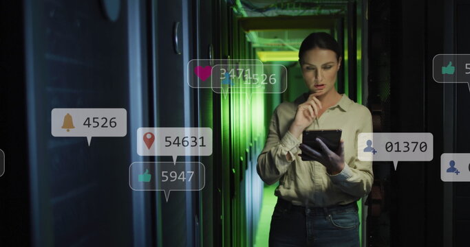 Image of social media icons over caucasian female engineer using digital tablet at server room - Powered by Adobe