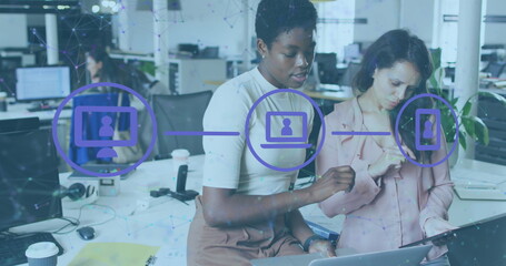 Image of flowchart of icons and connected dots, diverse female coworkers sharing ideas in office