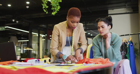 African American and biracial young professionals are examining fabric samples - Powered by Adobe