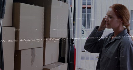 Image of financial graphs over caucasian female courier with packages using smartphone