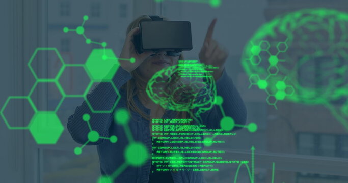 Image of data processing over caucasian woman using vr headset