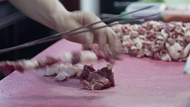Arranging Mutton and Tail Fat on Traditional Kebab Skewers Footage.