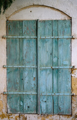 Fragment of windows with green shutters as a design element