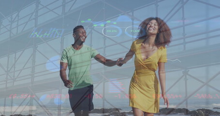 Fototapeta premium Image of hud interface, low angle view of bridge, african american couple running at beach