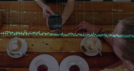 Image of financial data processing with statistics over woman holding payment terminal