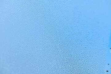 Condensation on window glass in frosty winter weather. Background in the form of small drops on the...