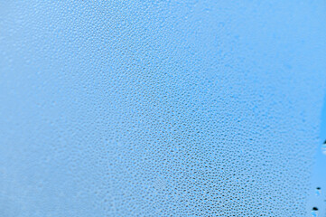 Condensation on window glass in frosty winter weather. Background in the form of small drops on the glass. 1